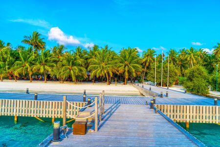 Wooden bridges leading to the huts on the shores of the tropicalの写真素材