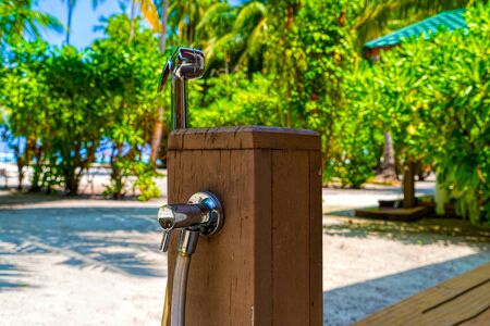 Metal round shower on a water villa on tropical island resortの写真素材