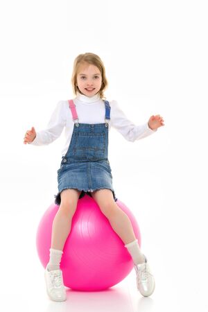 Little girl plays with a big ball for fitnessの写真素材