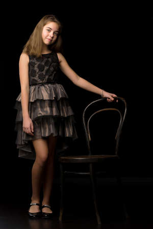 Beautiful young teen girl studio photo on black backgroundの写真素材