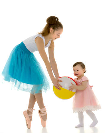 Graceful Ballerina Playing Ball with Adorable Smiling Toddler Girl.の写真素材