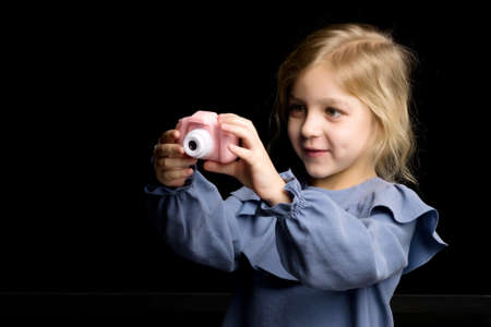 Beautiful Barefoot Girl Taking Photo with Toy Cameraの写真素材