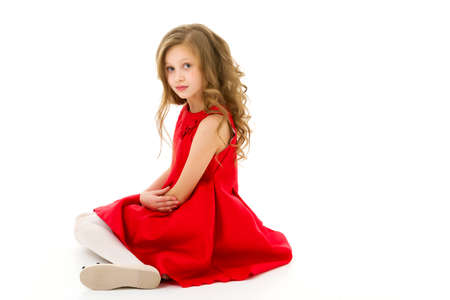 Cute Preteen Girl Sitting on the Floor with Her Knees Upの写真素材