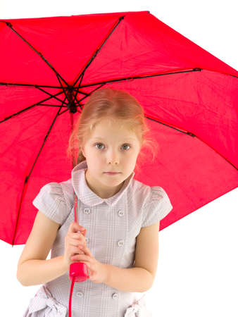 Little girl under an umbrella.Concept style and fashion. Isolated on white background.の写真素材