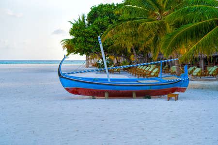 View of nice tropical beach with old boat
