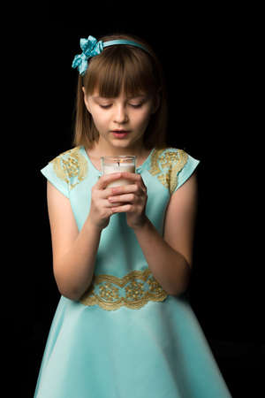 Little girl in a New Year costume with a candle.の写真素材