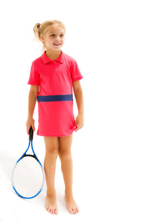 A little girl holds a tennis racket in her hands. Game, sports concept.の写真素材