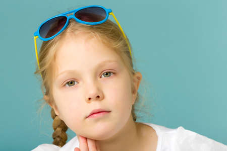 Little girl in sunglasses.The concept of youth fashion and style of clothes.の写真素材