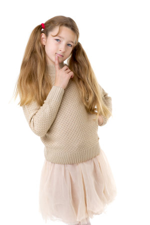 Thoughtful preteen girl. Posing against white background.の写真素材