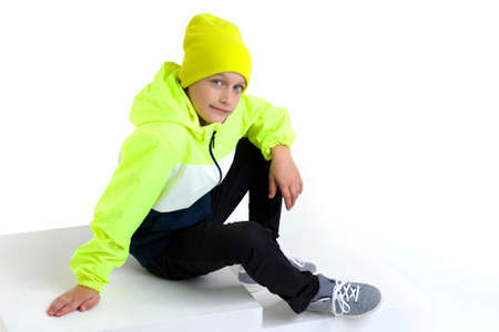 Cute stylish boy posing on staircase.studio photo of a handsome little boy.
