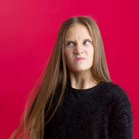 Portrait of teenage girl with funny grimaceの写真素材