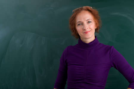 Teacher standing in front of blackboardの写真素材