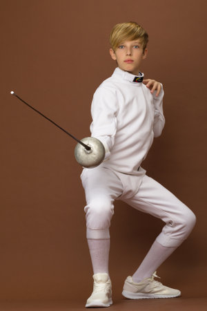 Boy fencer standing in attacking pose
