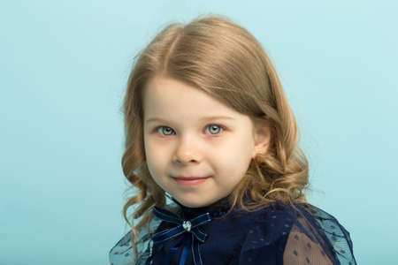 Portrait of a charming blonde in a beautiful lace dress. Close-up
