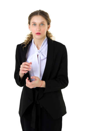 Upset student girl standing with hand on waistの写真素材