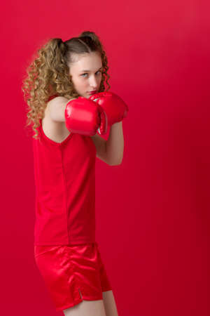 Sporty girl do boxing exercise in defensive stanceの写真素材