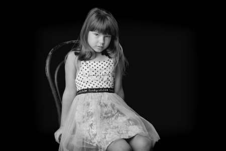 Beautiful happy girl sitting on chairの写真素材