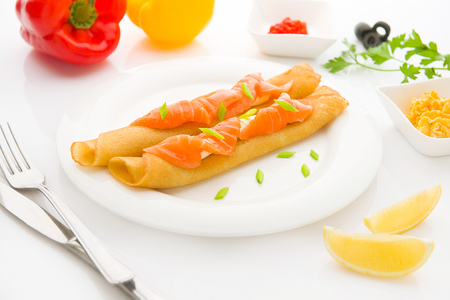 Breakfast with pancakes and salmon on white backgroundの写真素材