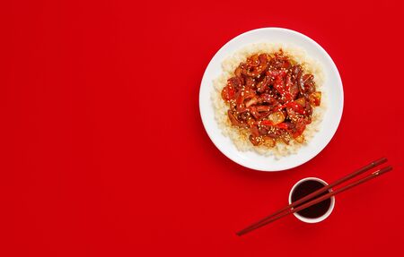 Sweet and Sour fried pork chunks with vegetables and rice. Top view with copy spaceの写真素材