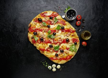 Top view of square pizza or pinsa with tuna on black slate backgroundの写真素材