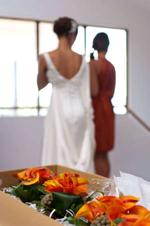 Wedding bouquet in foreground and Bride behind out of focusの写真素材