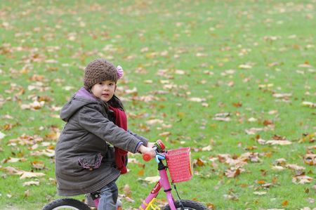 mixed-blood girl doing bicycleの写真素材