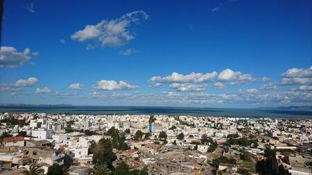 A panoramic view of an awesome small village by the sea with an awesome blue skyの写真素材