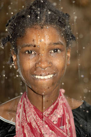 Young Swahili girl dancing in the rain on Chole Mjini Island near Zanzibar Island, Tanzaniaのeditorial素材