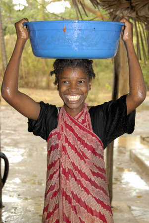 Young Swahili girl collecting rain water on Chole Mjini Island near Zanzibar Island, Tanzaniaのeditorial素材