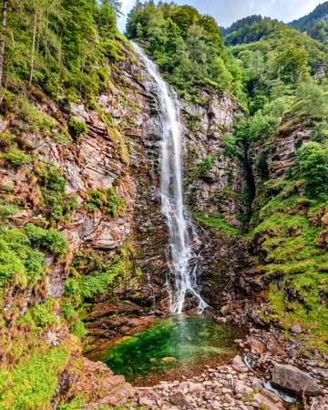 Small waterfall in the mountains. Beautiful summer landscape with waterfall in the forest.の写真素材