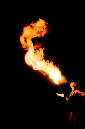 women Fire breather on black backgroundの写真素材