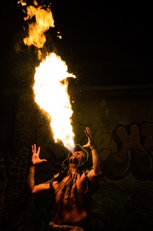 Men with tatoos costumed in shaman blowing   breathing fireの写真素材