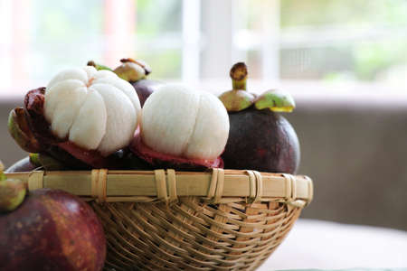Closed up group of queen of fruit fresh Mangosteen in bamboo basket healthy fruit high fiberの写真素材