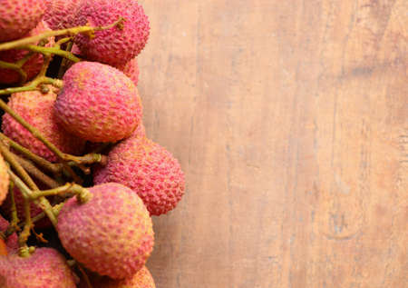 Selective focus top view fresh Lychee fruit on wood tableの写真素材