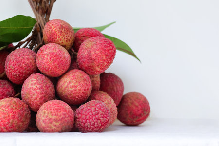 Closed up Litchi fresh fruits with leaves,  sweet and sour taste on isolate backgroundの写真素材