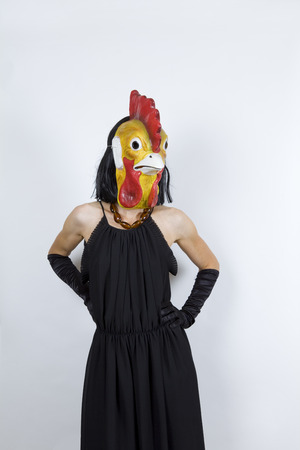 Woman wearing a cock mask with an evening dress and evening glovesの写真素材