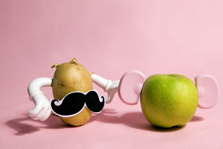 a pop and minimal potato portrait on a pink backgroundの写真素材