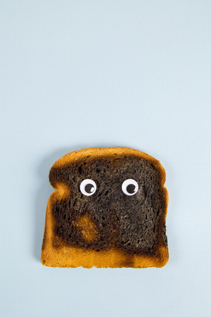 a quirky burned soft bread with eye's dollStill life and minimal photography
