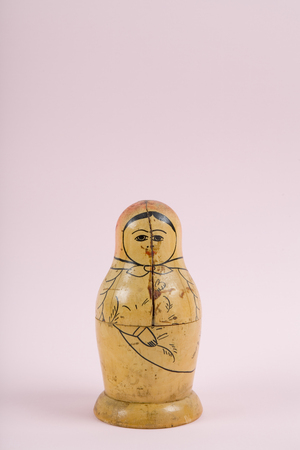 an old matrioshka on a vibrant pink background.Minimal color still life photographyの写真素材