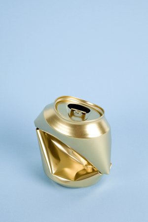 a crushed can of soda painted in gold on a colorful background.
Minimal color still life and quirky photographyの写真素材