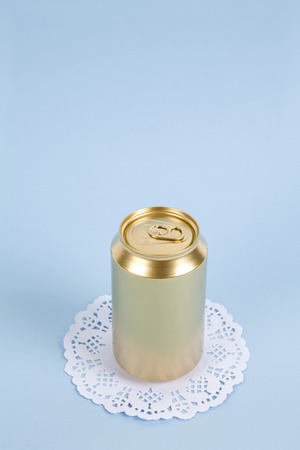 an unused can painted in gold on a virant colored background. Minimal color still life and quirky photographyの写真素材