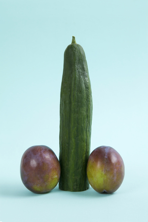 anthropomorphic still life photography with cucumber and plum in the form of a penisの写真素材