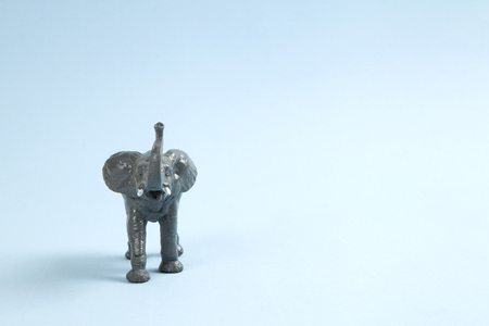a plastic elephant on a vibrant blue background. Minimal color still life photographyの写真素材