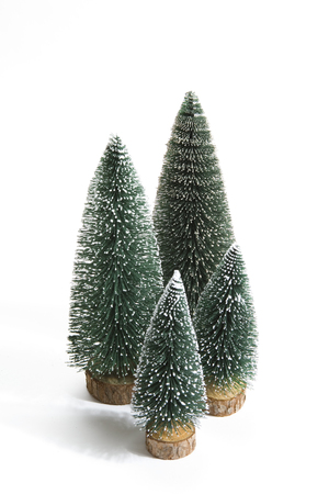 Isolated group of full artificial firs like a small forest tree on a white background. Minimal still life photographyの写真素材