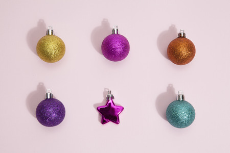 Set of sparkle Christmas balls on a pop pink color background. Minimal color still life photography.の写真素材