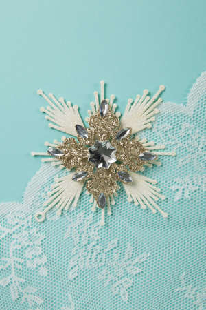 a snowflake, Christmas decoration on a blue background. Minimal and creative color still life photographyの写真素材
