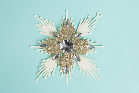 a snowflake, Christmas decoration on a blue background. Minimal and creative color still life photographyの写真素材