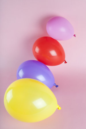 balloons in harmonious colors on a pink background. Minimal color still life photography.の写真素材