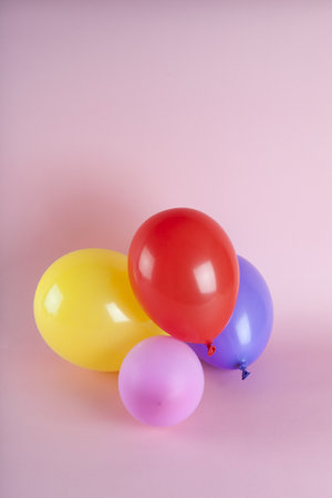 balloons in harmonious colors on a pink background. Minimal color still life photography.の写真素材