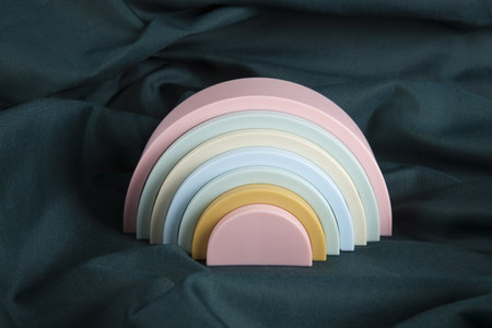 a plastic rainbow toy on a green curtain. Minimal color still life photography.の写真素材